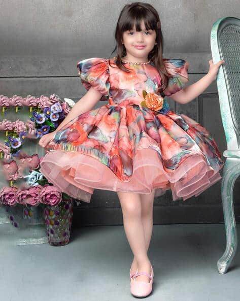 Girl in a peach puff-sleeve party dress